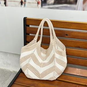 Large capacity beige and white zigzag crochet woven shoulder bag resting on wooden bench