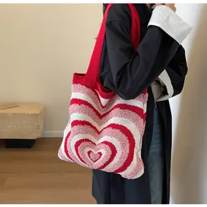 Knit tote bag detail, pink and red heart pattern, casual shoulder bag for daily use.