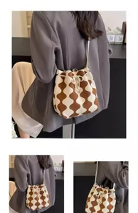 Detailed close-up showing the brown and white wavy pattern pleated drawstring bucket bag