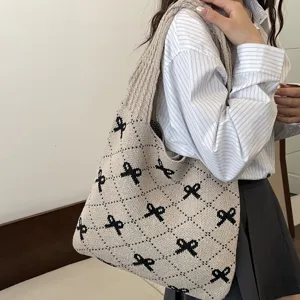 Fashionable knitted tote bag featuring black bow patterns and a large capacity design