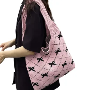 Stylish large capacity pink knitted tote bag featuring black bow patterns for women fashion