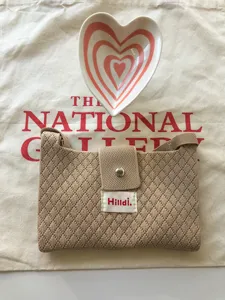 Knitted crossbody phone bag casual summer mini shoulder purse with flap button and cute label.