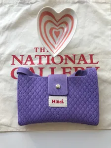 Purple knitted crossbody bag with metal snap closure, stylish casual phone pouch.
