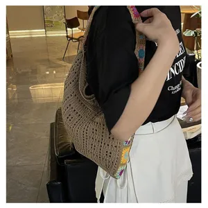 Detail view of a hand-woven Bohemian crochet tote bag being worn over the shoulder