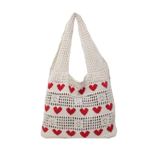 White crochet knit tote bag featuring red heart patterns and hollow-out design.
