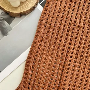Macro detail showing the intricate brown hollow knitted pattern of this retro woven tote bag