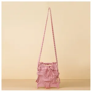 Front view of pink knitted crossbody bag featuring a unique pleated woven design for women