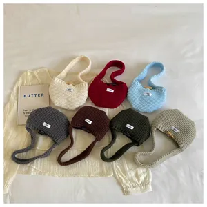 Set of seven colorful knitted wool mini handbags and earphone pouches in various shades