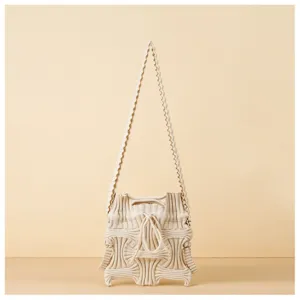 Detailed view of architectural pleated knit texture on cream designer shoulder bag.