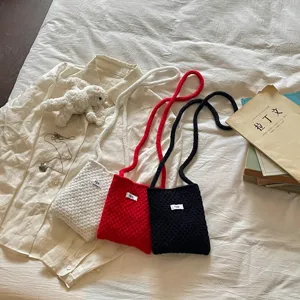 Handmade knitted mini crossbody bag in white, red, and black candy colors