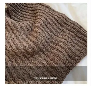 Close-up macro view showing the intricate brown knitted texture of a summer tote bag