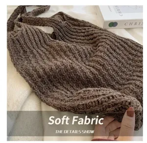 Detailed macro view showing the soft brown knitted fabric of a crochet tote bag