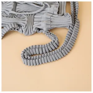 Macro view of gray knitted pleated crossbody bag showing intricate ribbed texture detail