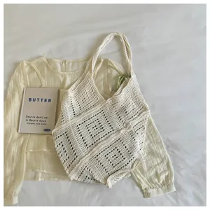 Detailed shot of cream white Bohemian knit hollow-out large capacity beach tote