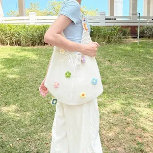 Detailed view of the handmade crochet shoulder bag with colorful floral embroidery, casual style.