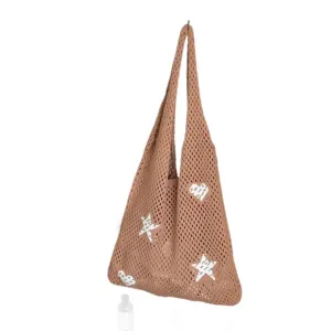 Khaki crochet woven tote bag with white star and heart patterns for summer holidays.