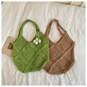 Two bohemian crochet knitted beach tote bags in green and brown with flower charm