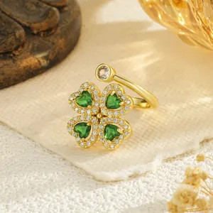 Close-up of a rotatable four-leaf clover ring with green heart-shaped zircon stones