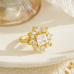 Detailed close-up of a gold-plated spinning ring featuring a square zircon and floral design.