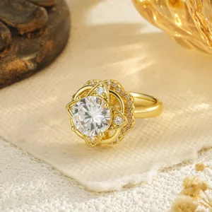 Macro view of a gold-toned rotatable flower ring with sparkling center stone.
