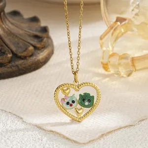 Close-up of heart hollow pendant necklace with green enamel kitten design