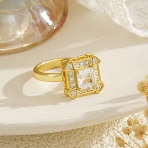 Macro view of a gold square halo rotatable ring featuring sparkling cubic zirconia stones
