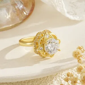 Close-up detail of an elegant gold floral rotatable spinning ring with crystal center