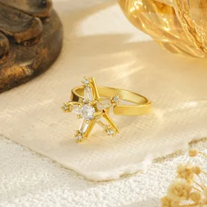 Detailed view of an elegant golden star-shaped copper ring with sparkling white zircon inlays