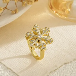 Detailed macro view of a rotating gold snowflake ring with sparkling zircon stones