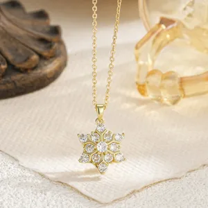 Elegant rotating snowflake pendant necklace with sparkling cubic zirconia in gold finish.