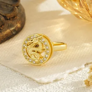 Detailed macro view of a gold-plated spinning ring with dragon motif and zircon inlay