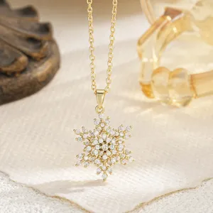 Elegant gold-plated snowflake pendant necklace adorned with shimmering cubic zircon stones
