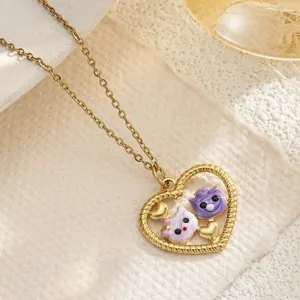 Macro detail of heart-shaped hollow necklace pendant with colorful enamel cats
