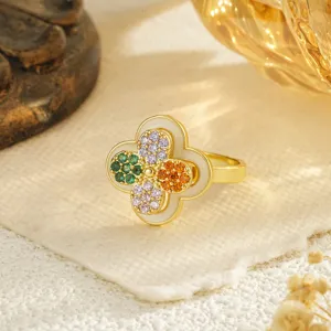 Detailed view of a rotating four-leaf clover ring featuring multi-colored cubic zirconia stones