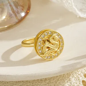 Detailed macro view of a golden decompression rotating dragon ring with shimmering zircons