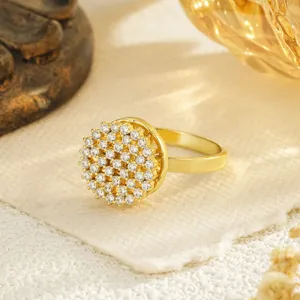 Close-up of a luxurious gold-plated spinning ring featuring a dazzling zircon flower cluster