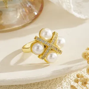 Close-up of rotatable flower ring with pearls and zircon in gold finish