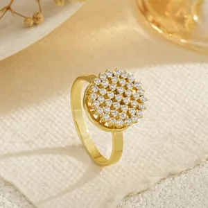 Detailed macro view of a gold-plated rotating ring featuring sparkling round zircons