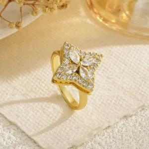 Macro view of gold rotating ring with sparkling zircon four-leaf clover design