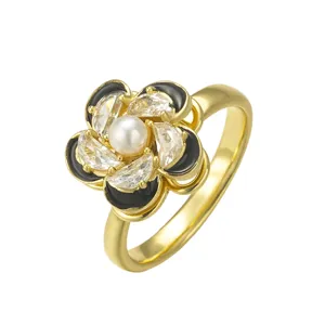 Elegant gold-finished rotatable flower ring featuring a center pearl and sparkling zirconia