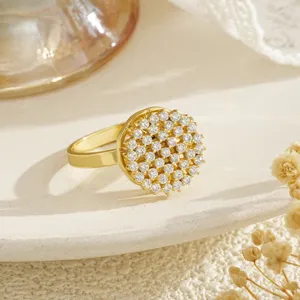 Detailed macro shot of a gold-plated rotating ring featuring cluster-set sparkling zircons