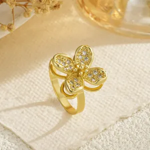 Macro view of gold-plated clover ring with micro-paved sparkling cubic zirconia