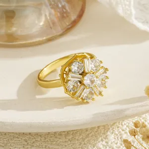 Detailed view of gold-plated rotating flower ring with sparkling zircons
