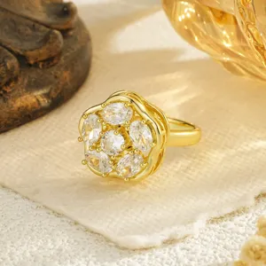 Detailed view of an elegant gold-plated rotating flower ring with sparkling cubic zirconia