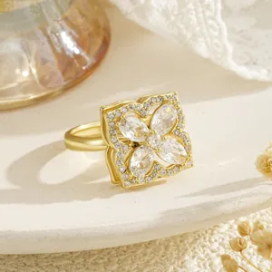 Detailed close-up of a rotating gold clover ring featuring marquise-cut sparkling zircons