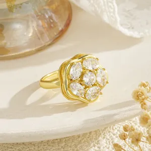 Detailed macro view of gold-plated rotating flower ring with sparkling cubic zirconia stones