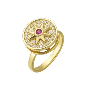 Elegant gold plated rotating stress relief ring with sun star motif and clear zirconia stones