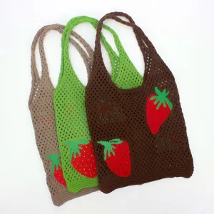 Trio of colorful knitted mesh tote bags with vibrant strawberry embroidery details.