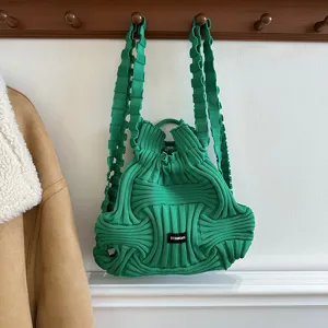 Macro view showing the unique green knitted texture of this casual woven backpack.