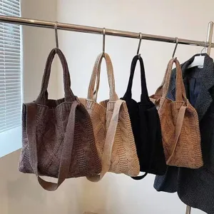 Detailed shot of large capacity cable knit tote bags in various neutral autumn colors